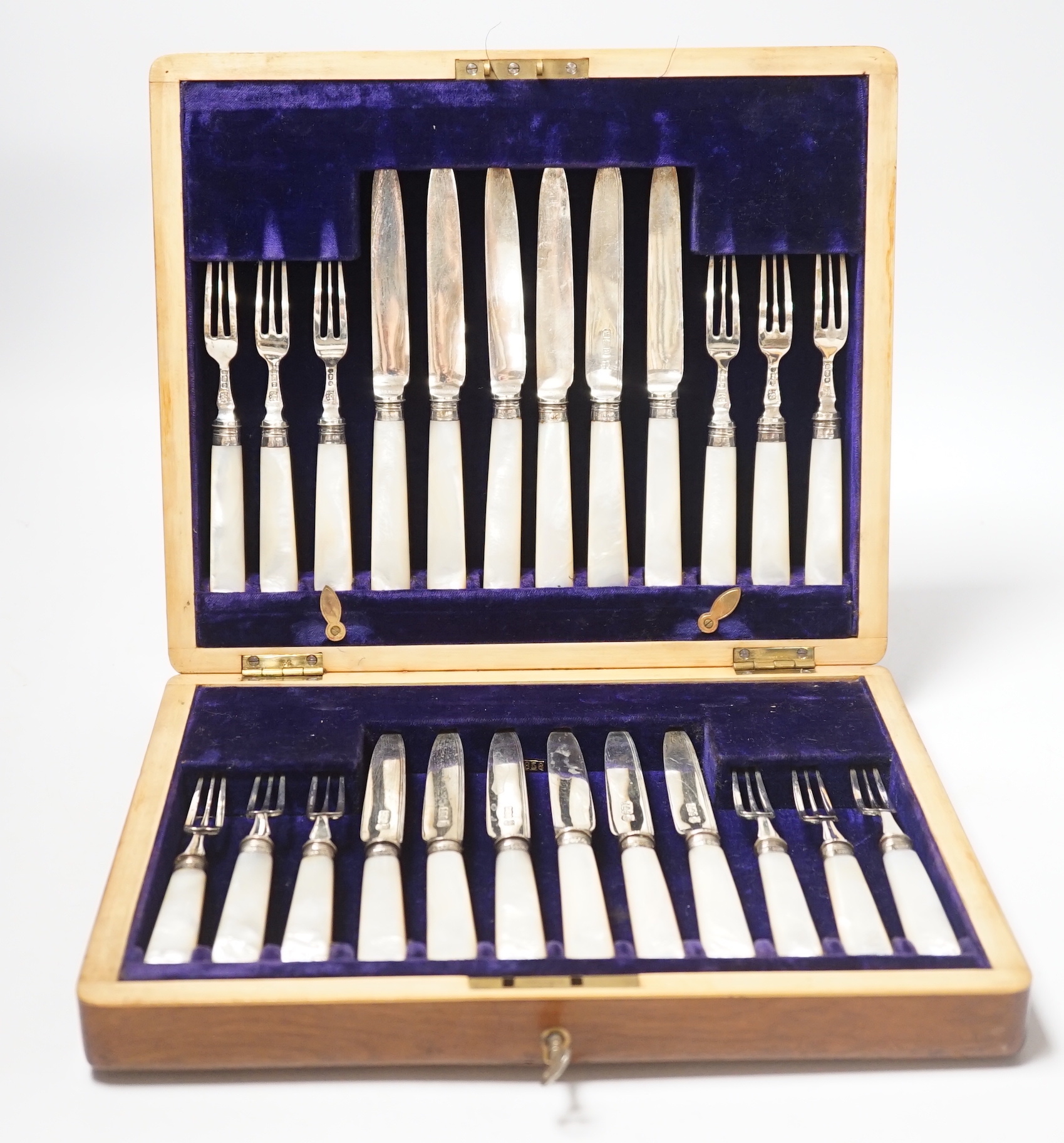 An Edwardian cased set of twelve pairs of silver and mother of pearl handled dessert eaters, Frederick C. Asman & Co, Sheffield, 1905, box 29.2cm.